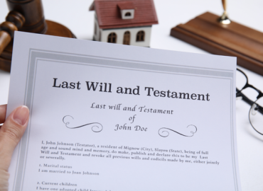 woman holding last will and testament at white table closeup
